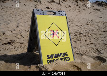 Danger no swimming sign on a sandy beach Stock Photo