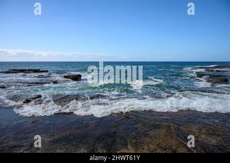 waves breaking on rocks in Australia Stock Photo