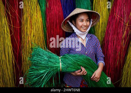 Vietnamese women drying traditional vietnam mats in the old traditional village at dinh yen, dong thap, vietnam, tradition artist concept,Vietnam. Stock Photo