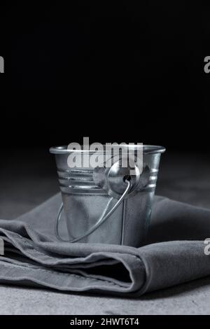 Mini aluminium bucket on the table, space fot text Stock Photo