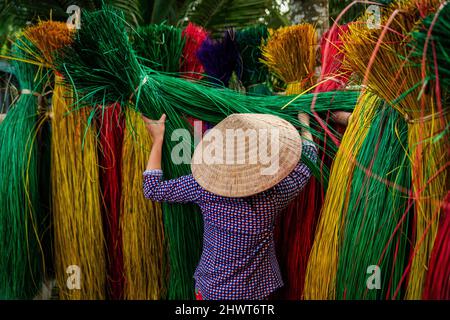 Vietnamese women drying traditional vietnam mats in the old traditional village at dinh yen, dong thap, vietnam, tradition artist concept,Vietnam. Stock Photo