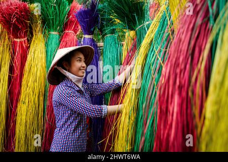 Vietnamese women drying traditional vietnam mats in the old traditional village at dinh yen, dong thap, vietnam, tradition artist concept,Vietnam. Stock Photo