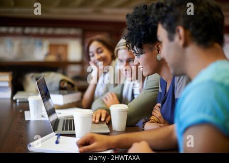 Working together to prepare for finals. A group of young people studying together for the upcoming exams. Stock Photo