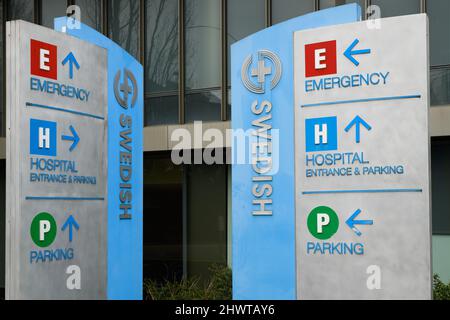 Seattle, WA, USA - March 06, 2022; Signs at Swedish Medical Center at First Hill Campus in Seattle for Emergency, Parking, and Hospital Stock Photo