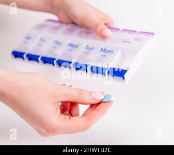 Woman hands taking pill or vitamin from box. Health care and medical treatment concept. High quality photo Stock Photo