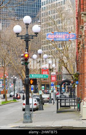 Seattle, WA, USA - March 06, 2022; 1st Avenue South in the Pioneer Square neighborhood of Seattle historic street light fixtures and neon sign Stock Photo