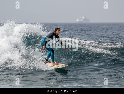 Surfers catching the waves near Playa de las Americas, Tenerife Stock Photo