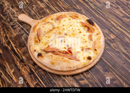 The pizza with fried egg is an opportunity to enjoy a delicious homemade pizza, being able to choose the flavors that you most wan Stock Photo