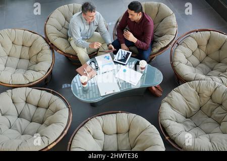 Finance department managers analyzing reports at meeting, view from the top Stock Photo