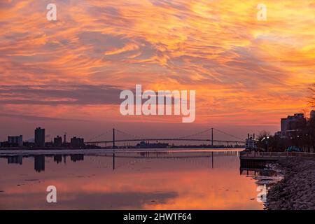 Detroit, Michigan - The Detroit River and Ambassador Bridge at sunset. Stock Photo