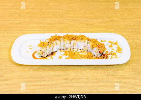 Dragon roll is one of the most popular sushi, it is cooked in the form of 'uramaki', it presents the rice on the outside, placing the nori seaweed bet Stock Photo