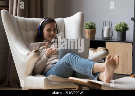 Woman use laptop talks to friend through video conference Stock Photo