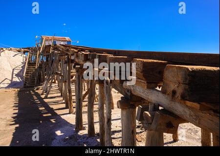 Narrow gauge railway on lakes for salt mining in the south of the Dominican Republic. Wide angle, Copy space, High quality photo. Iron standard-gauge Stock Photo