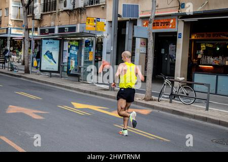 Tel Aviv, Israel - February 25, 2022 Runners in the street of Tel Aviv at the Marathon which takes place on February 25 after a year-long hiatus follo Stock Photo