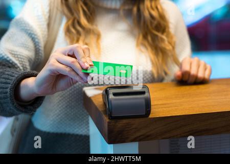 Woman paying with credit card via terminal Stock Photo