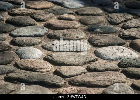 Stone pavement on street in old town closeup as stone background Stock Photo