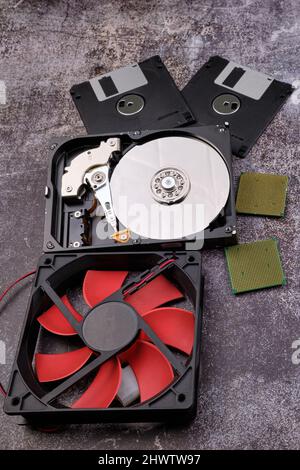 Technological background formed by different components of a computer on a table with a color similar to cement and with empty space. Stock Photo