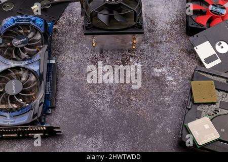 Technological background formed by different components of a computer on a table with a color similar to cement and with empty space. Stock Photo