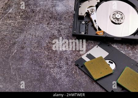Technological background formed by different components of a computer on a table with a color similar to cement and with empty space. Stock Photo