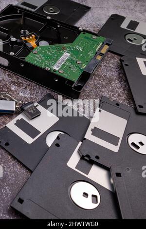Composition of various computer components on a dark background similar to cement. Stock Photo