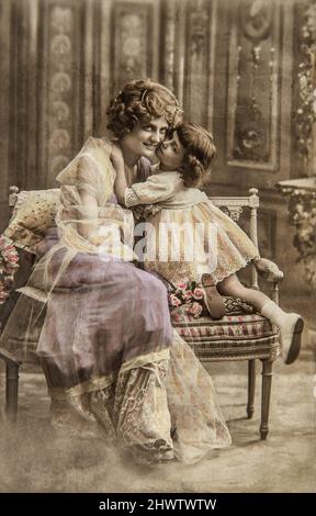 Vintage portrait of lucky mother with cute daughter wearing retro clothing Stock Photo
