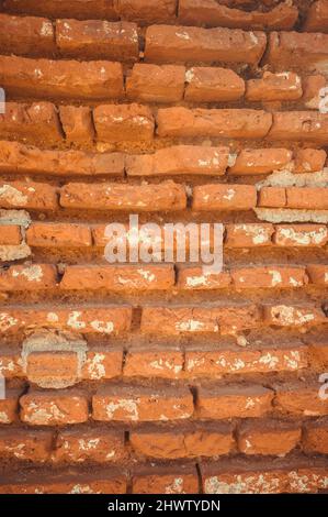 Old red brick wall. Photo of surface of vintage stony wall. Wide angle. Vintage brickwork view. Orange stone constitution. Exterior antique element of Stock Photo