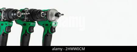 Drill. Set of cordless drills on a white background. Tool for drilling and making holes. Screwdriver set with high capacity spare batteries. Stock Photo