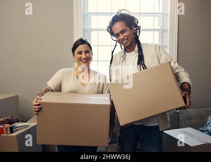 We cant wait to start unpacking. Shot of a happy young couple moving into their new home. Stock Photo