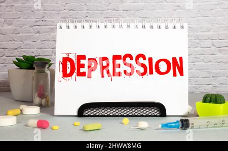 Depression word on lightbox on modern yellow office desktop. Stock Photo