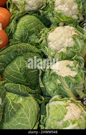 Primeur fruits and vegetables. Detail of cauliflowers and green cabbage at a greengrocer Stock Photo
