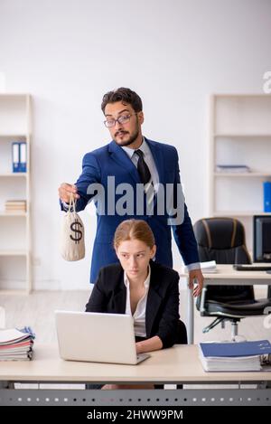 Boss and young secretary in remuneration concept Stock Photo - Alamy