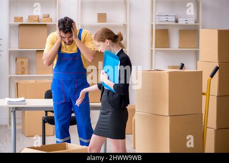Female boss and male contractor doing home relocation Stock Photo