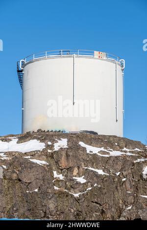 Helsinki / Finland - FEBRUARY 26, 2022: Closeup of an abandoned oil container standing on top of a granite hill Stock Photo
