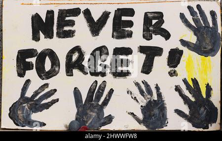 A sign never forget is on display among some children's shoes at the memorial for the mourning of the First Nation Kids Stock Photo