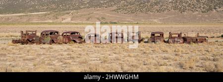 Old rusted cars in the desert area Stock Photo
