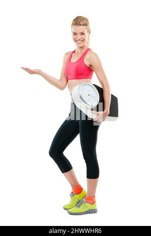 Only you can change you. Studio shot of an athletic young woman holding a scale. Stock Photo