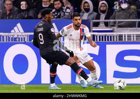 Lyon, France - February 27: Emerson Palmieri of Lyon (R) dribbles Jonathan Davi of Lille (L) during the Ligue 1 Uber Eats match between Olympique Lyon Stock Photo
