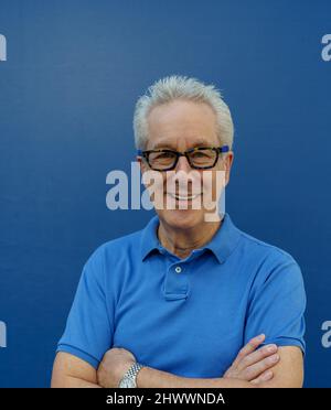 Smiling man with arms crossed Stock Photo