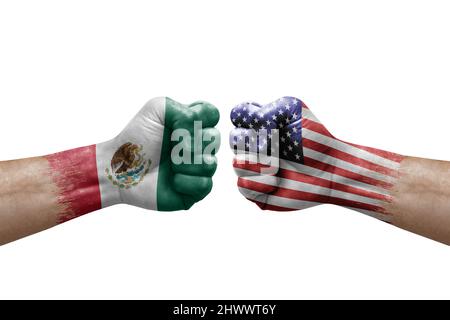 Two hands punch to each others on white background. Country flags painted fists, conflict crisis concept between mexico and usa Stock Photo