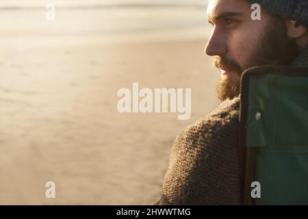 Taking a break. SIde view of an attractive man looking into the distance. Stock Photo