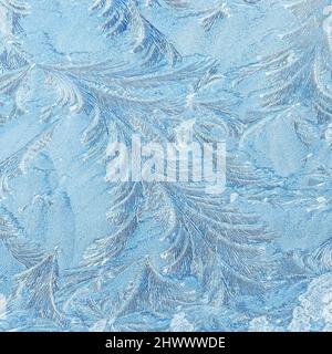 Ice and frost on car window creating abstract floral patterns Stock Photo
