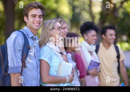 Excited about college. A group of students standing in a line on campus. Stock Photo