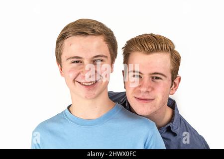 Two caucasian boys brothers posing in studio Stock Photo - Alamy