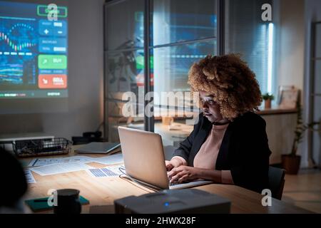 African businesswoman working on laptop while sitting at board room and preparing for the conference Stock Photo