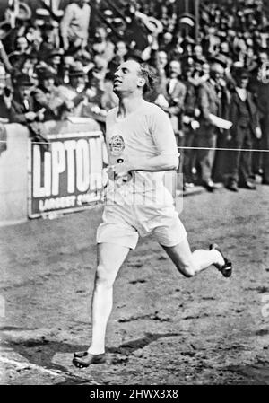 Scottish Olympic athlete Eric Liddell winning the British Empire vs. USA 1-mile relay at the International Athletics Meeting held at Stamford Bridge, London on Saturday, July 19, 1924, following the Paris Olympics. Due to personal convictions of his Christian faith, Liddell famously refused to run his favored 100 meters in the 1924 Olympics because the race was held on a Sunday. He instead competed in the 400 meter race, which he won. In 1925 Liddell returned to China (where he was born) and served as a missionary there until his death in 1945 in a Japanese civilian internment camp. Stock Photo