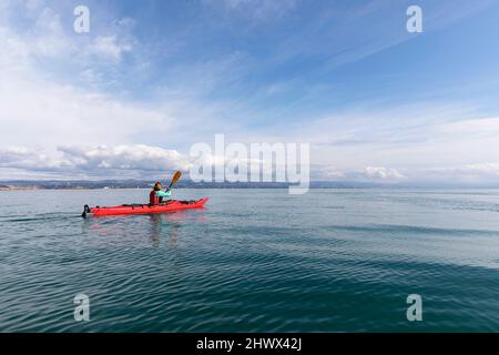 Woman kayaking at Isonzo river's mouth - Regional Nature Reserve of the Foce dell'Isonzo, Friuli Venezia Giulia region, Italy. Stock Photo