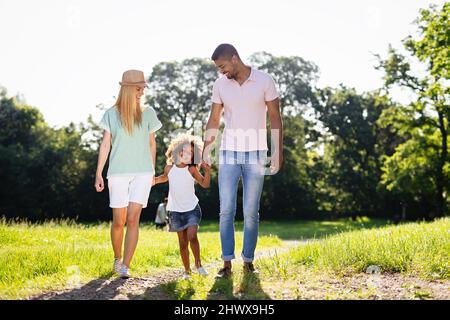 Happy multiethnic family having fun together outdoors. People love happiness concept Stock Photo