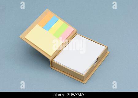 Cube note paper and stickers on the blue background. Stock Photo