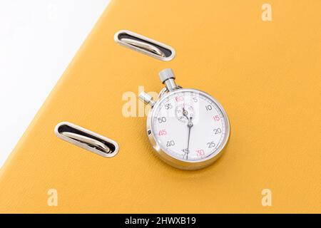 Yellow office folder on the chronometer. Stock Photo