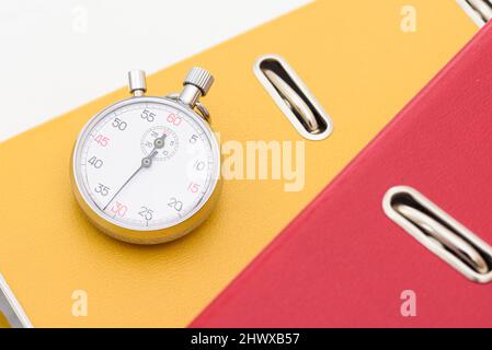 Yellow office folder on the chronometer. Stock Photo